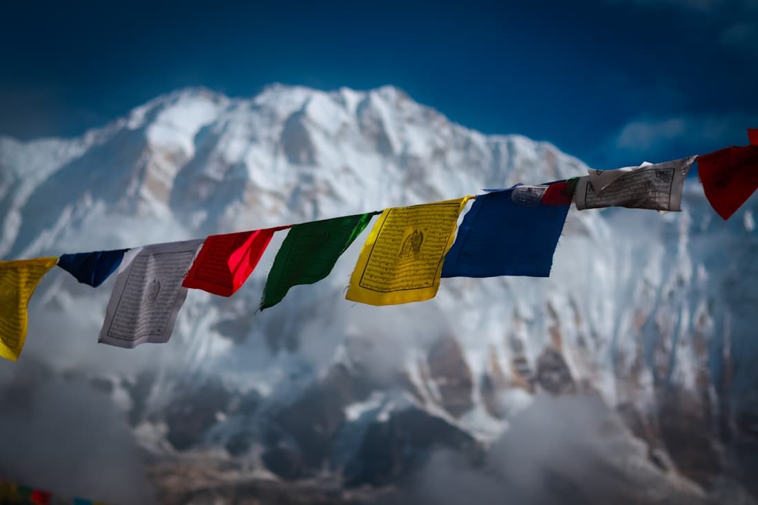 Buddhist prayer flags against a snow-capped Himalayan peak