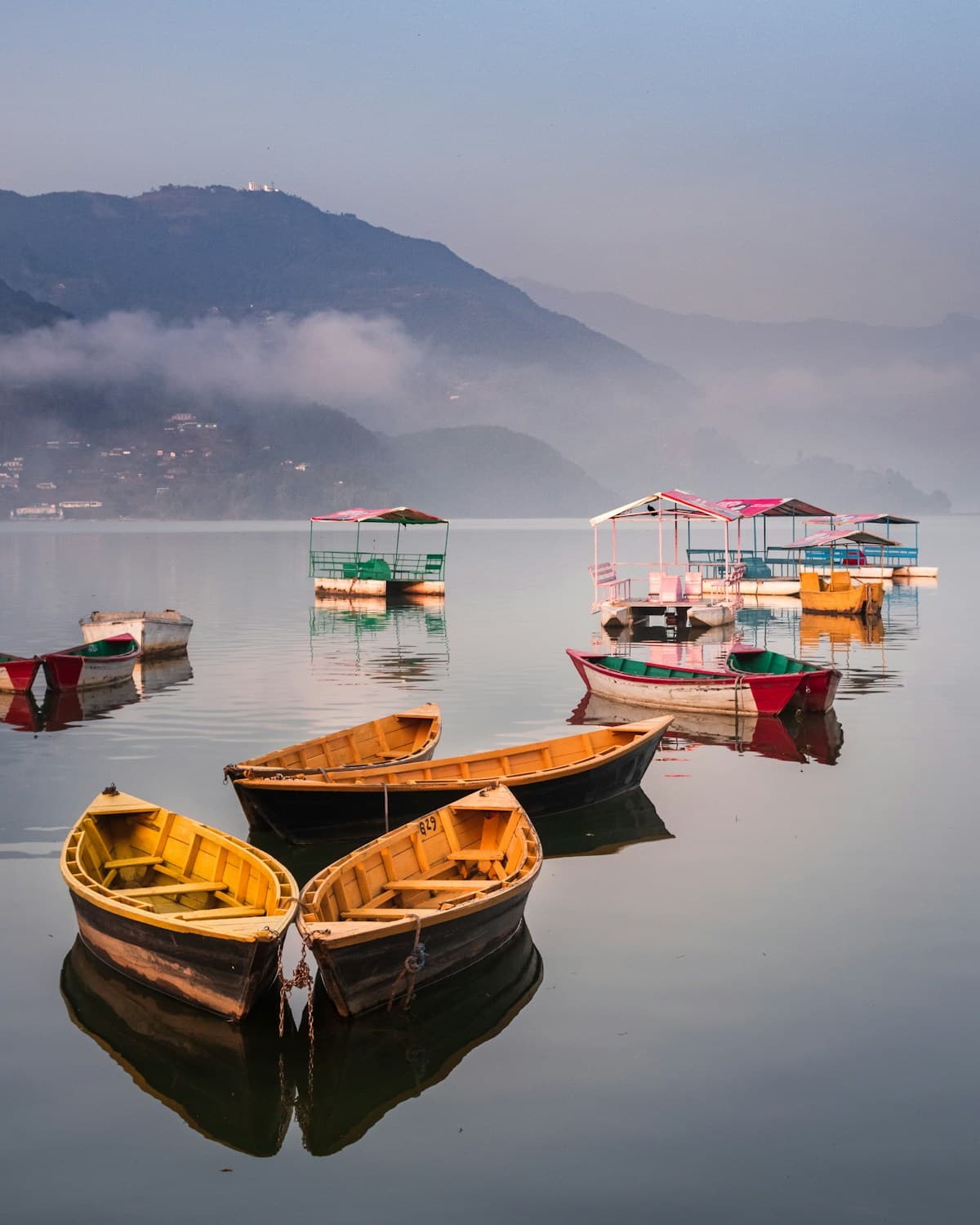A group of colourful boats floating on Phewa Lake in Pokhara